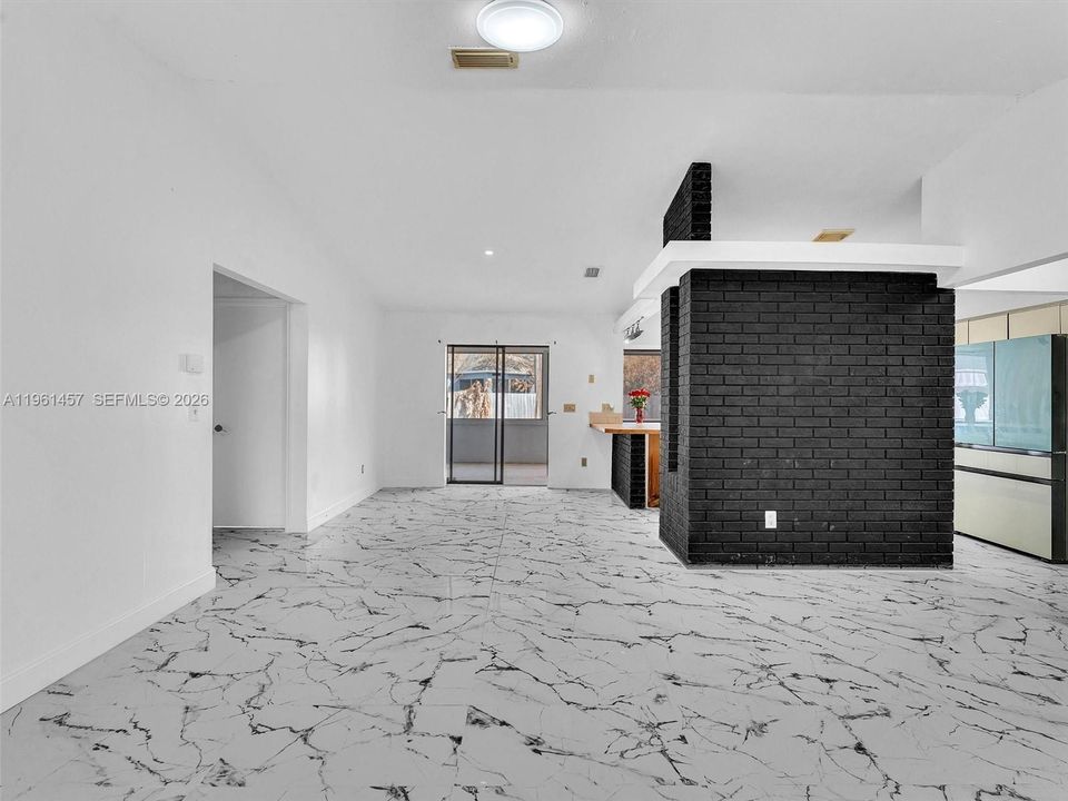 living room facing kitchen wall