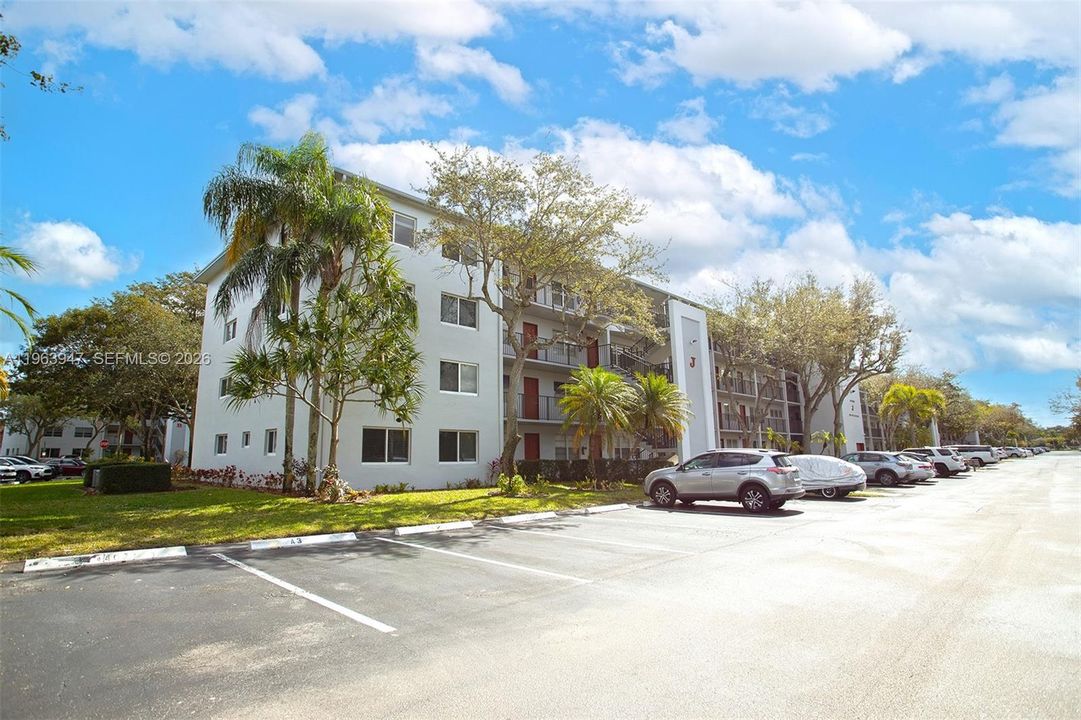 FRONT OF BUILDING AND SEVERAL GUEST PARKING