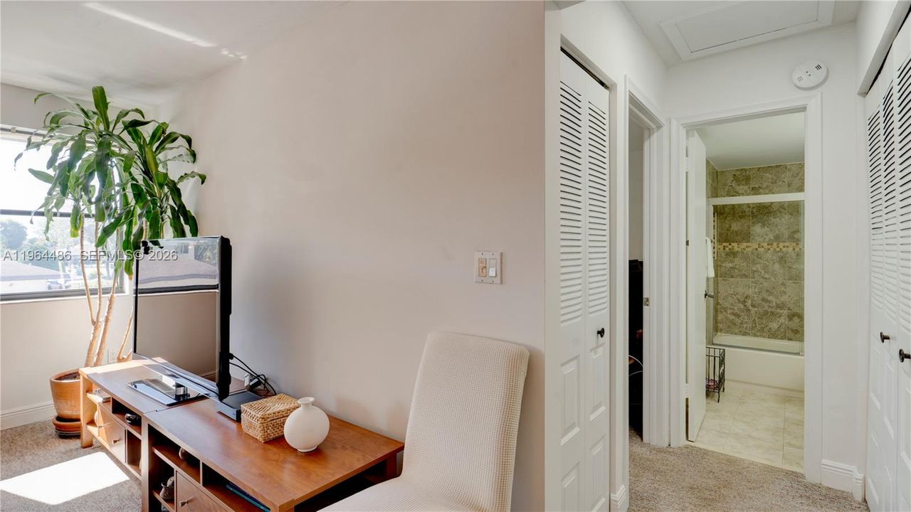 View from Living room leading to second bedroom and bathroom, with linen close and large side by side closet