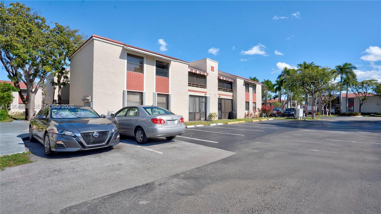 Corner 2nd floor condo with screened porch & parking right in front as well as ample guest parking