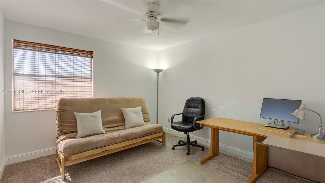 2nd bedroom with large window and side by side closet