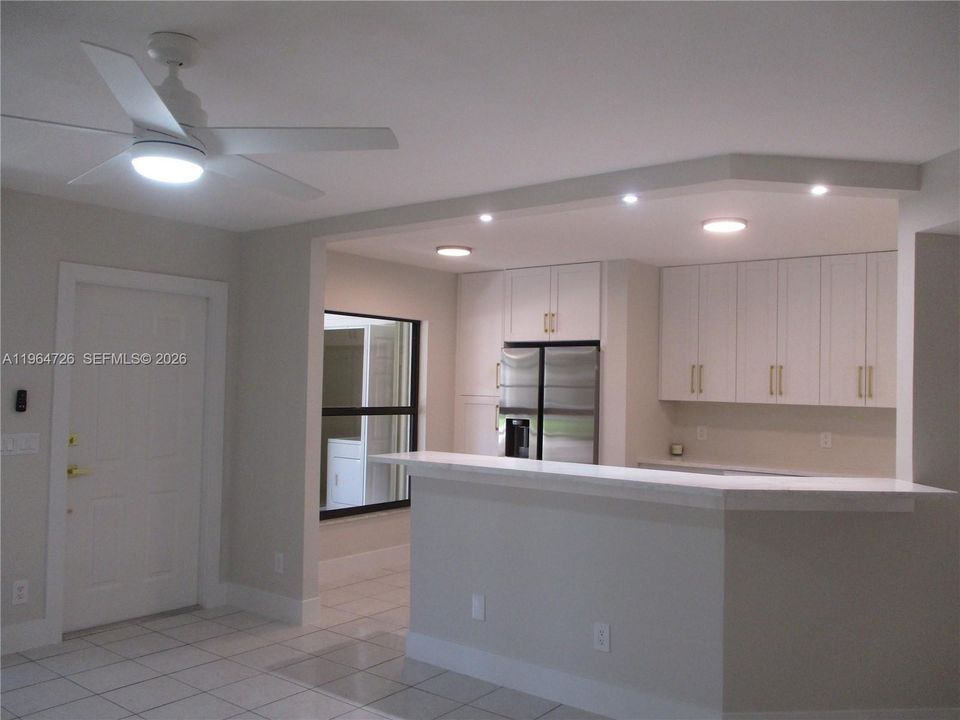 VIEW FROM LIVING INTO KITCHEN WITH PANTRY