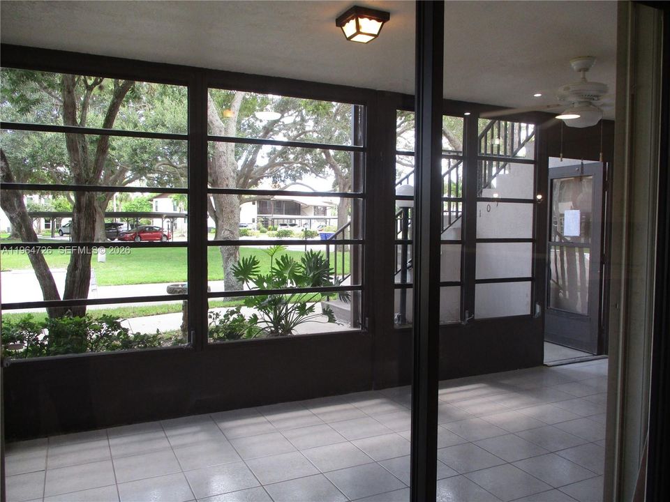 LOOKING OUT FROM LIVING AREA TO PATIO
