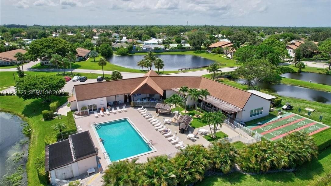 VIEW OF CLUBHOUSE & POND SURROUNDING THE COMMUNITY