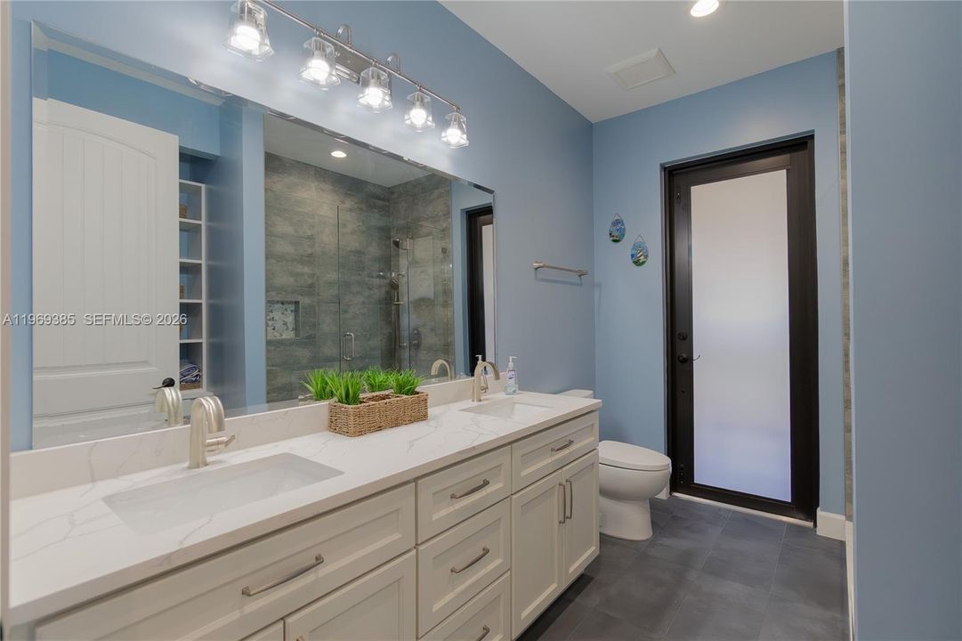 Beautiful spacious cabana guest bathroom with double vanities and....