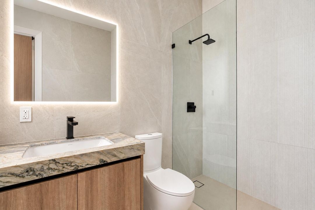 Pristine bathroom with backlit LED mirro