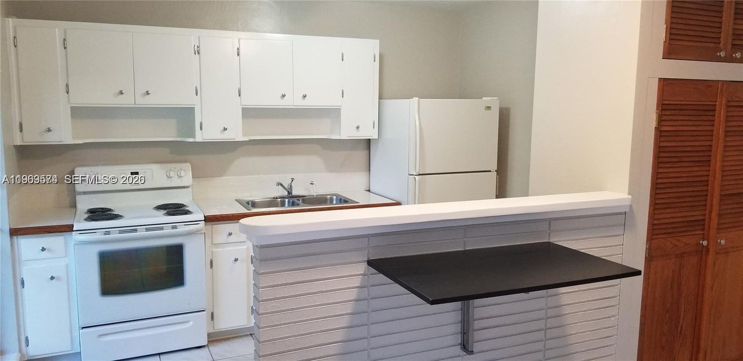 Folding table attached to high counter top