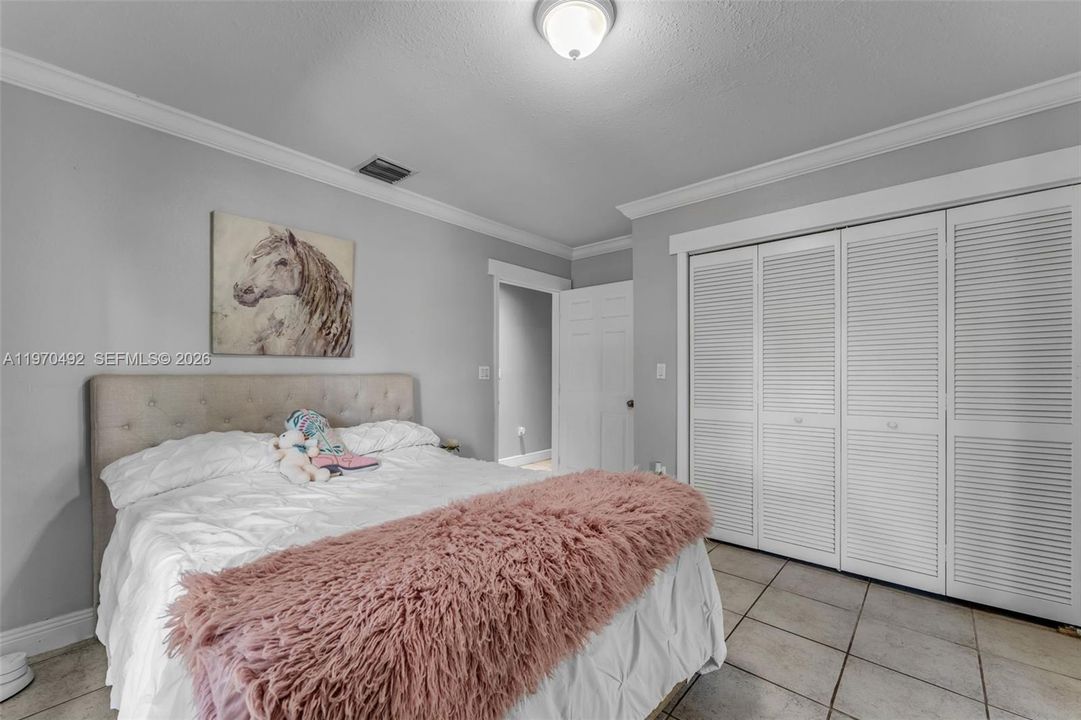Bedroom #2 with 2 French doors leading to the wrap around patio.