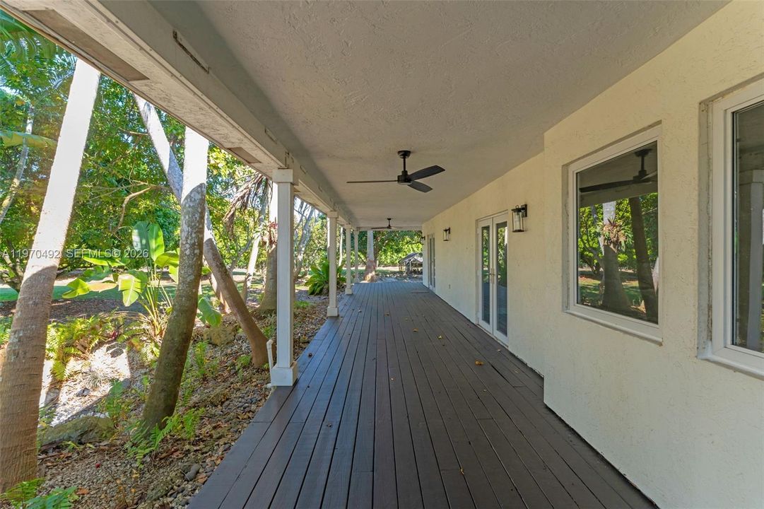 3/4 Wrap around patio upon entry w/ new ceiling fans & custom lighting