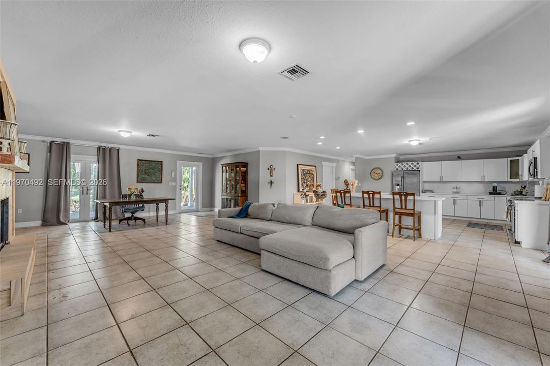 Open floor plan concept w/ fireplace and 2 sets of french doors leading to the front and back patio's, huge slider off of the kitchen. light and bright!