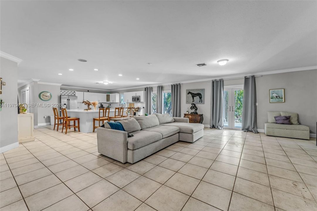 Open floor plan concept w/ fireplace and 2 sets of french doors leading to the front and back patio's, huge slider off of the kitchen. light and bright!