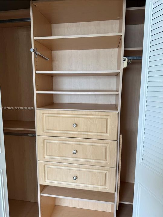 Master Bedroom closet finished with drawers and shelves