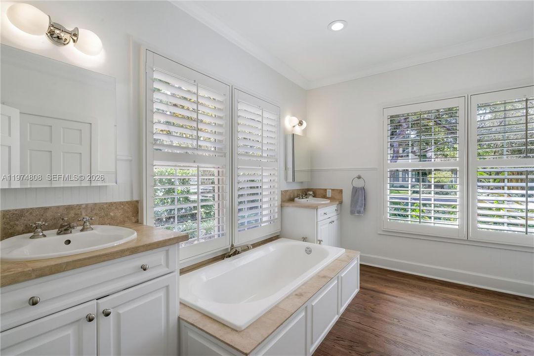 Enjoy the two separate areas, including the soaking tub, in this primary bathroom.