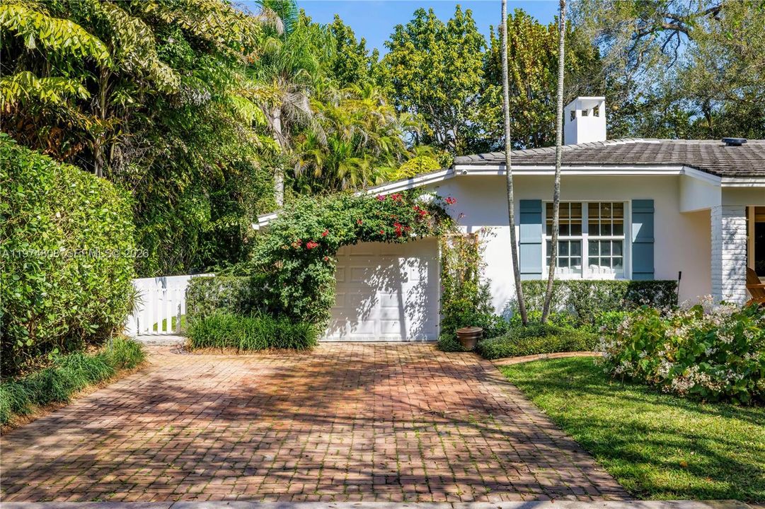 West side of property with white picket fence accessing the backyard.