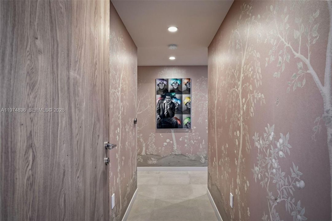 Beautifully finished private primary suite with hallway to two large walk in closets and an oversized bath with dual sinks, a large marble shower and Roman tub.