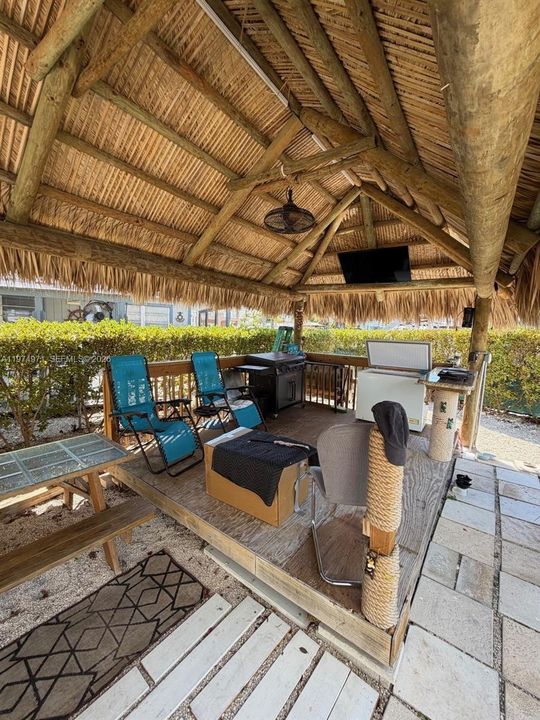 Tiki with BBQ and sitting area for entertainment