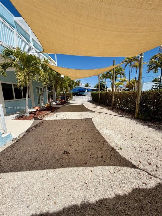 Side entrance and driveway towards Tiki Bar and pool area