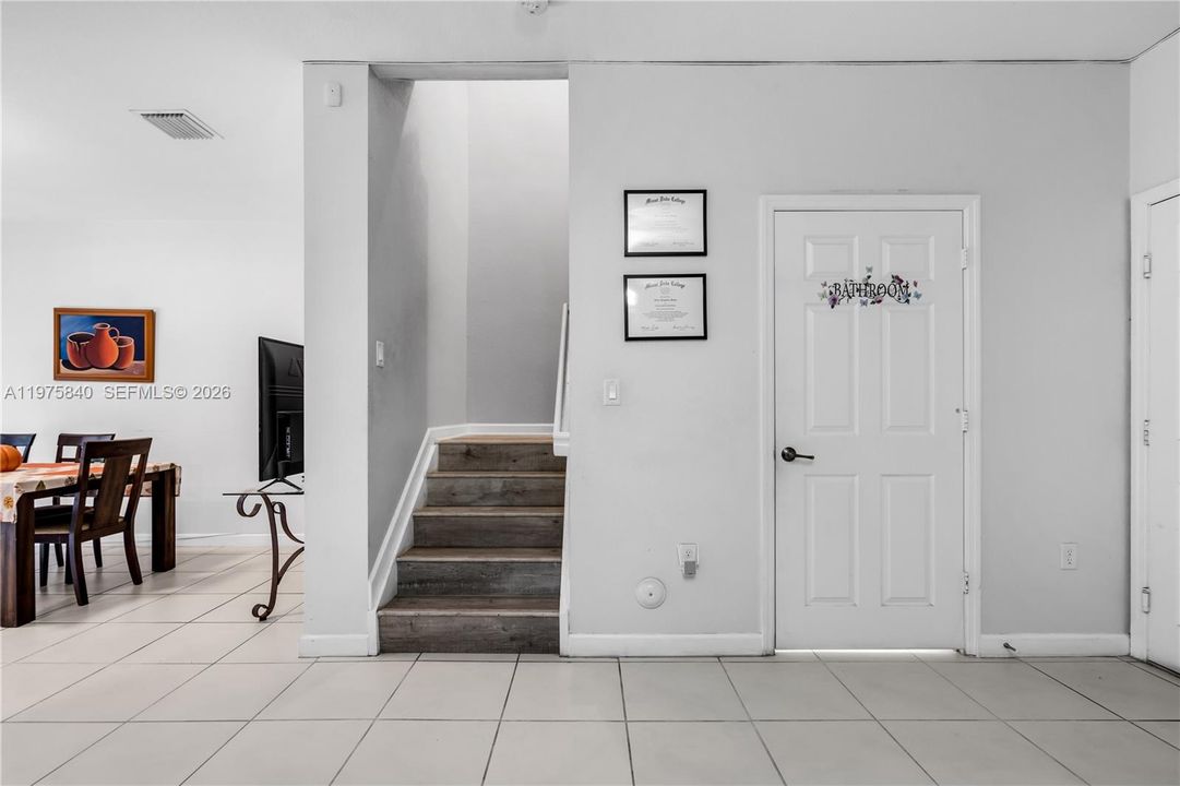 Stairs to the second floor and powder bathroom