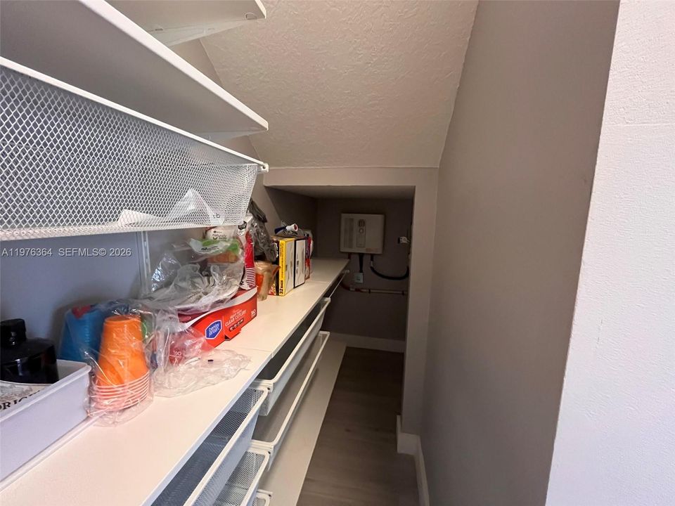 At the back of pantry is the on-demand water heater