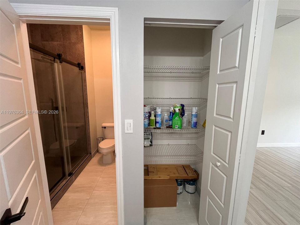 Shower & toilet in adjacent room to master bath vanity & tub and linen closet taken at 0.5