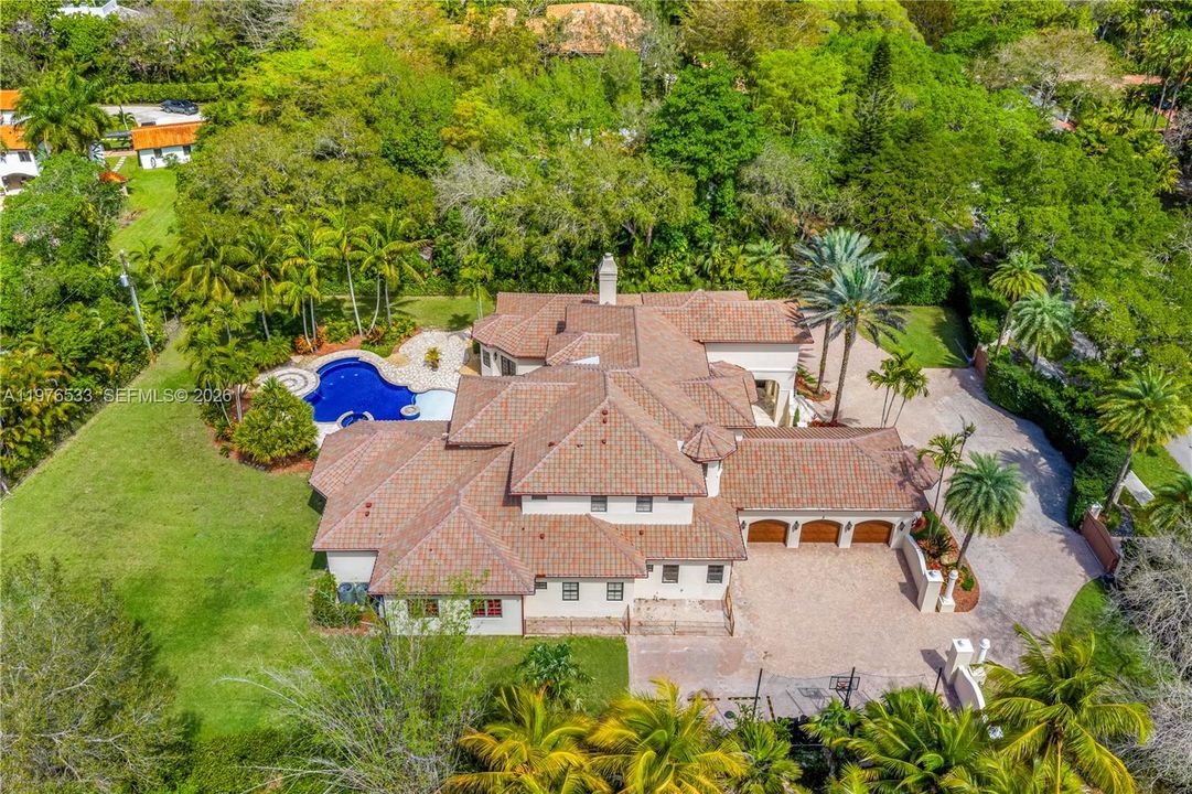 A true estate set on more than 45,000 SF of beautifully landscaped grounds.