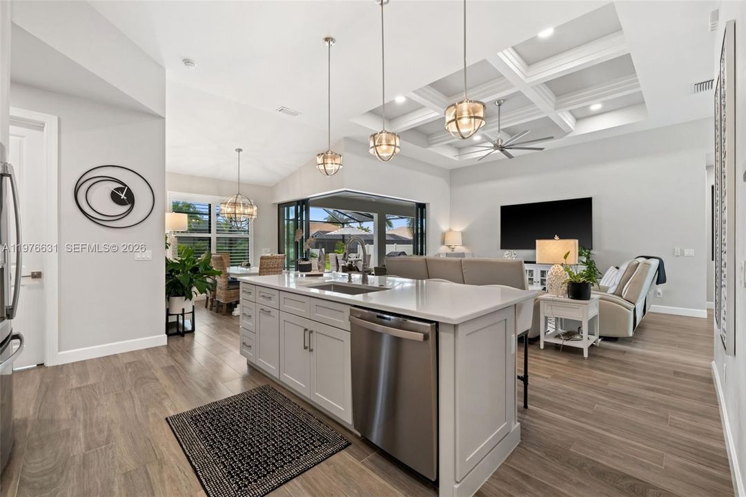 Kitchen island with pendant lighting and breakfast bar