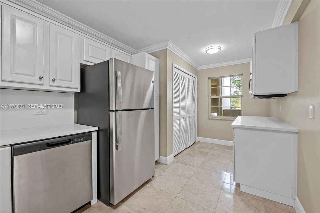 Kitchen with extra storage cabinets and laundry area