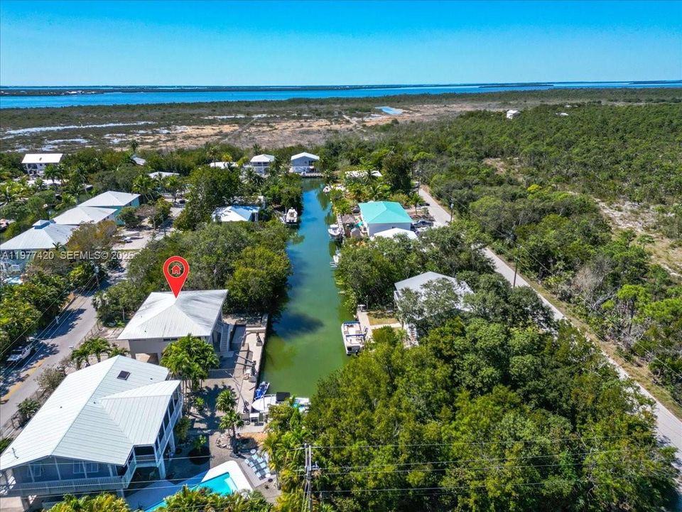 Bird’s-eye view of the property with canal frontage and waterfront setting.