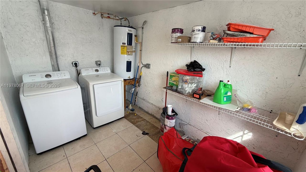 Laundry room and outdoor storage closet. Water heater, washer and dryer