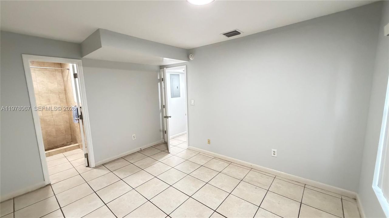First floor room/den with a full bathroom