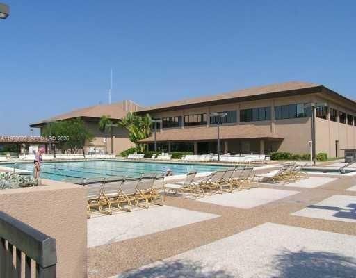 STUNNING CLUBHOUSE LAKEFRONT OUTDOOR POOL w/ PLENTY OF LOUNGING AREAS