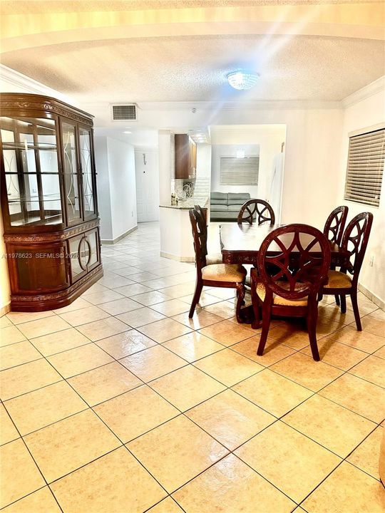 VIEW FROM LIVING AREA TO ENTRANCE HALL, DINING AREA, KITCHEN & BONUS NOOK