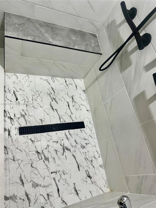 BEAUTIFULLY TILED FOR A STYLISH VISUAL DESIGN CONTRAST- FULL BENCH FOR COMFORT/SAFETY/RELAXATION-UPGRADED DRAIN ADDS TO THE SPA LIKE AESTHETIC