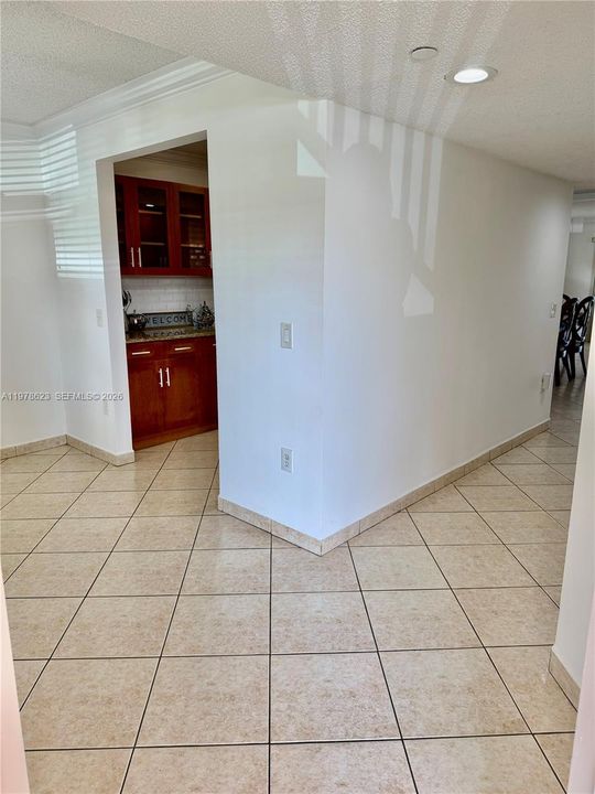 GALLEY KITCHEN OFF OF NOOK & DINING AREA-FEATURING WOOD CABINETS-GRANITE COUNTERTOPS-WHITE APPLIANCES