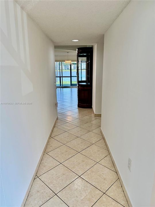 WATER & GARDEN VIEWS UPON ENTERING-UNIT IS DIAGONALLY TILED IN SAME TILE THROUGHOUT THE UNIT