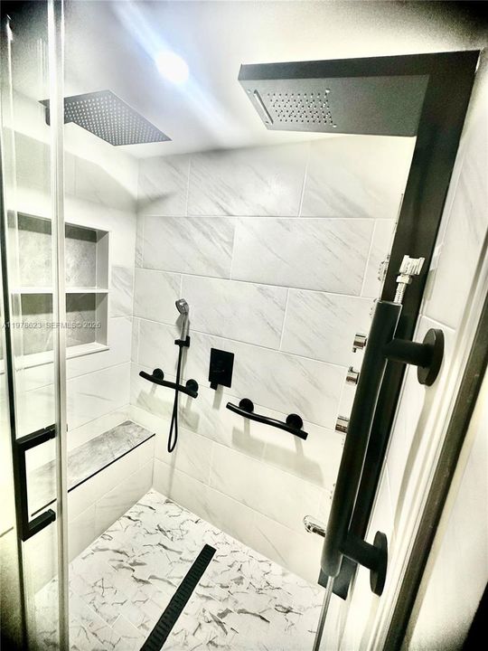 DESIGNED WITH STYLE & FUNCTIONALITY IN MIND-BUILT IN BENCH WITH EASY ACCESS HAND HELD SHOWER HEAD & 2 OVERHEAD RAIN SHOWER HEADS-DECORATIVE SAFETY BARS & TILED WALL ORGANIZER FOR ALL YOUR SPA SHOWER NEEDS