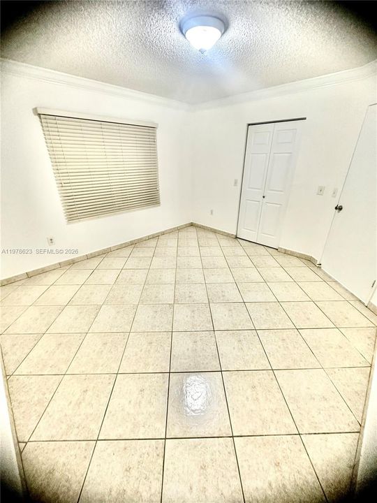 1st BEDROOM WITH WINDOW TO FRONT OF UNIT-ACCORDION DOOR TO WALK IN CLOSET & WITH PROXIMIY TO BATHROOM GIVES IT A JUNIOR SUITE FEEL