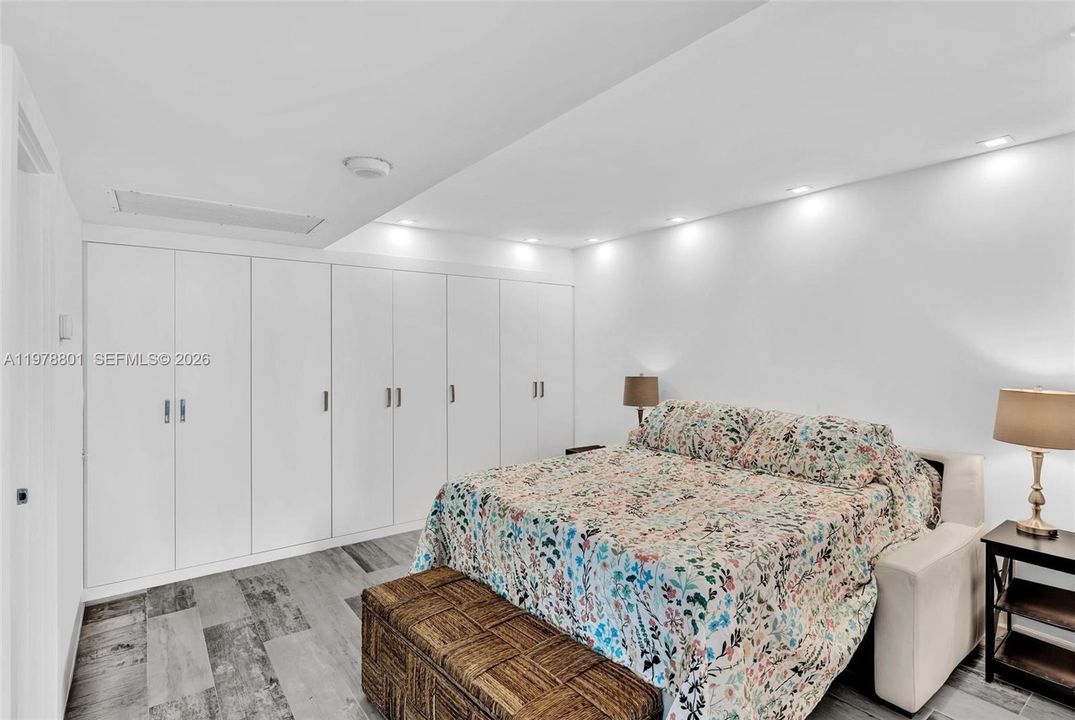 Primary with wall of closets and walk in