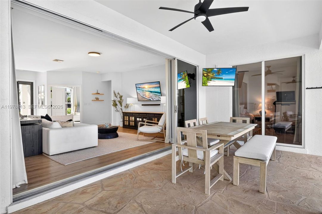 Outdoor patio dining area, sliders fully open for seamless indoor/outdoor living