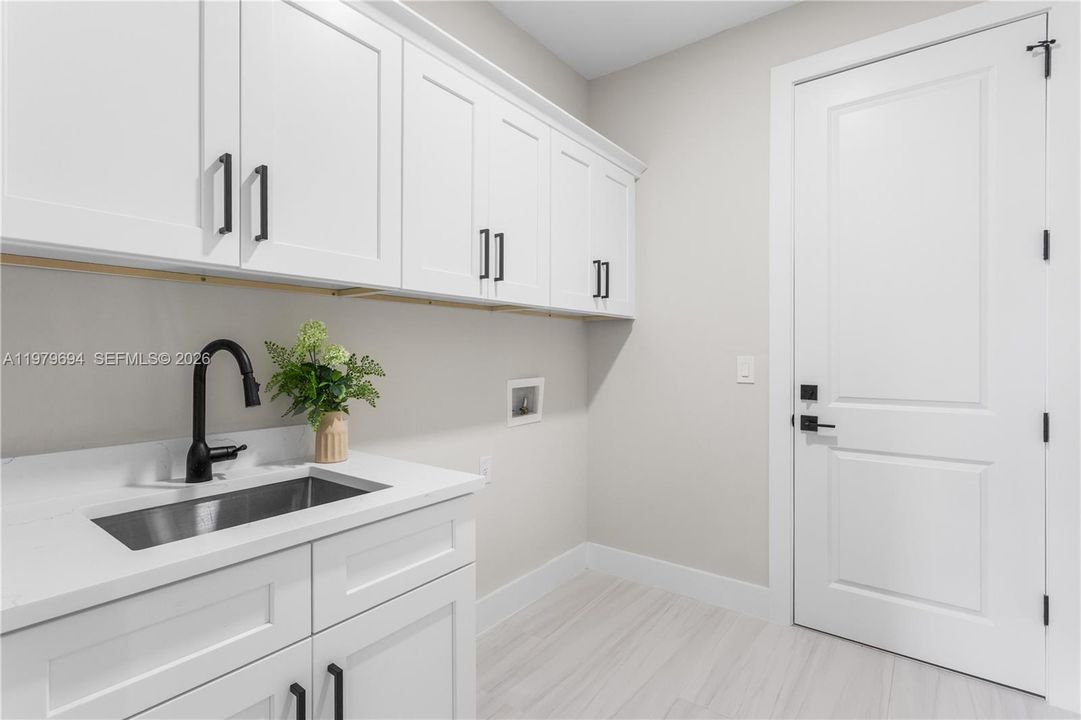 Laundry tub and custom cabinetry for added storage :)