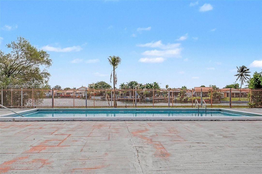 One of the Community Pools, steps from property