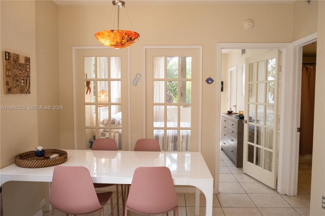Dining area is surrounded by large windows and charming French doors creating an open and inviting space for family/friends to gather and eat.