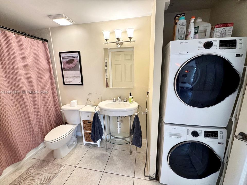 Full-sized Washer/Dryer inside laundry.