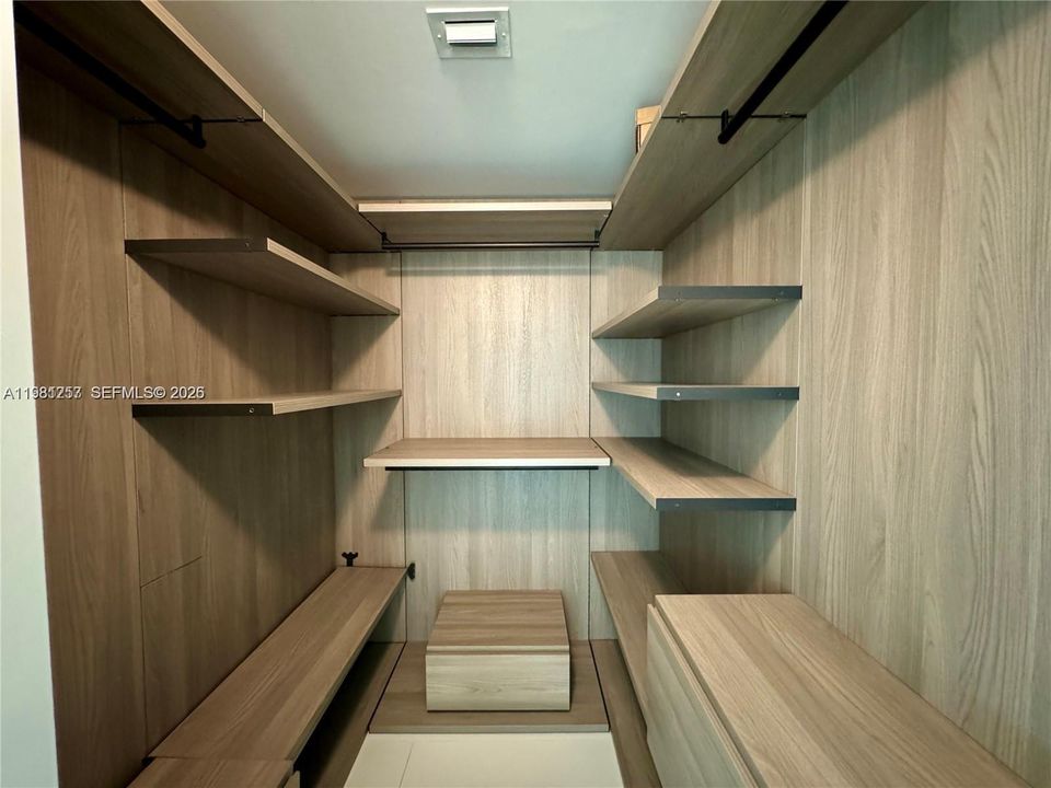 Primary bedroom walk-in closet