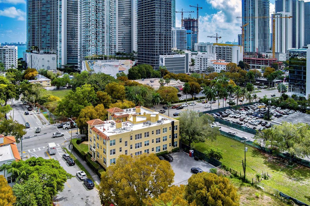 Aerial view of building, gated parking