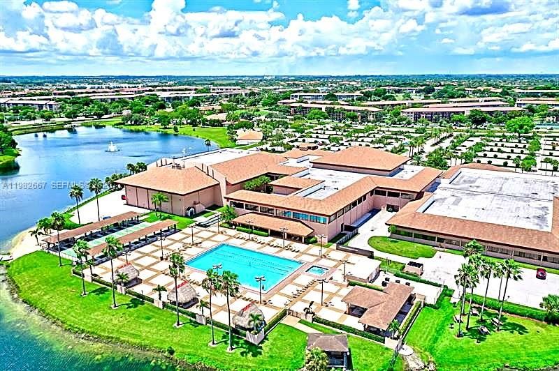 Aerial view highlighting clubhouse, pools and surrounding lakes.