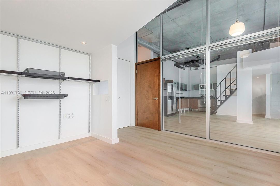 Bedroom has glass enclosure & privacy shades.