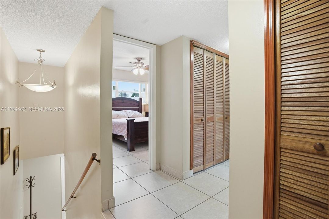 The staircase leads you to a private upper level where both bedrooms and a conveniently located laundry area await a two-story layout that truly sets this condo apart.