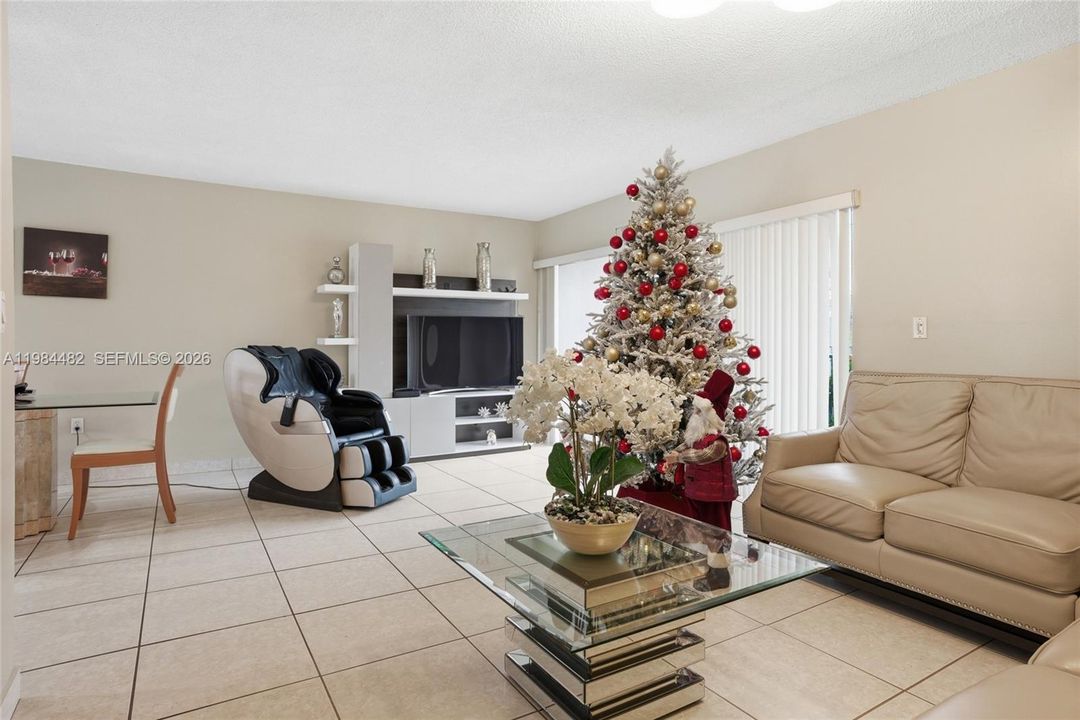 The living room flows effortlessly to your private balcony, blurring the line between indoor comfort and the warm Miami outdoors.