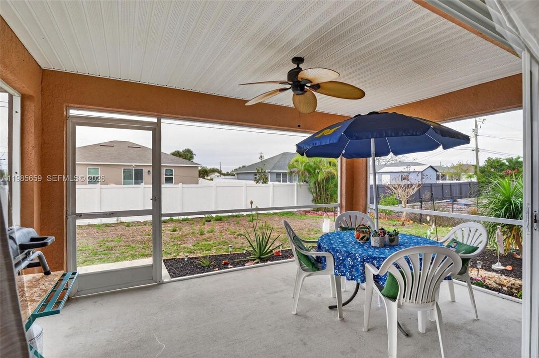 Large patio under roof and new screens and ceiling, with ceiling fan